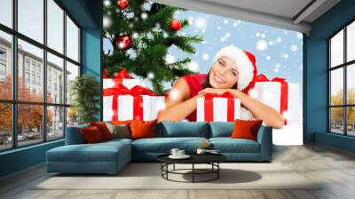 smiling woman in santa helper hat with gift boxes Wall mural