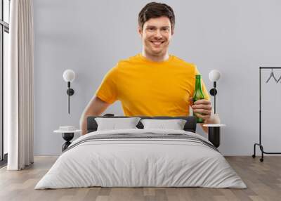 sport, leisure games and people - happy man or football fan in yellow t-shirt with soccer ball and beer bottle over grey background Wall mural