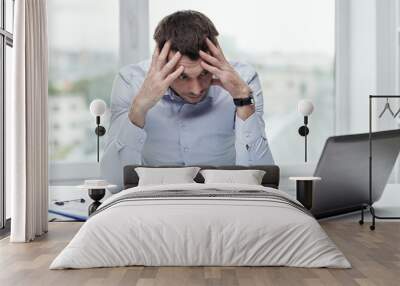 stressed businessman with laptop at office Wall mural