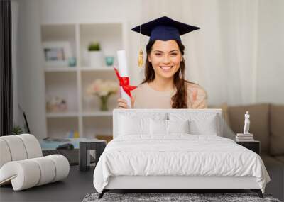 student with diploma at home showing thumbs up Wall mural