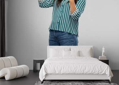 success, winning gesture and people concept - happy young asian woman celebrating victory over grey background Wall mural