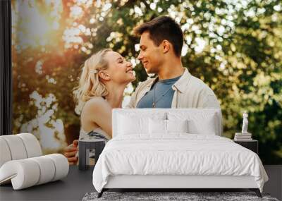 summer holidays, love and people concept - happy young couple hugging outdoors Wall mural