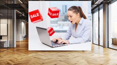 surprised businesswoman with laptop and sale signs Wall mural