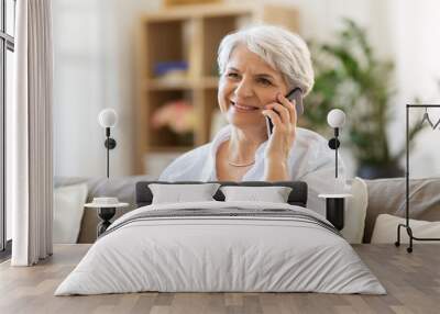 technology, communication and people concept - happy senior woman calling on smartphone at home Wall mural