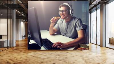 technology, gaming, entertainment, let's play and people concept - happy young man in headset with pc computer eating pizza while playing game at home and streaming playthrough or walkthrough video Wall mural