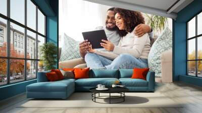 technology, internet and people concept - happy african american couple with tablet computer at home Wall mural