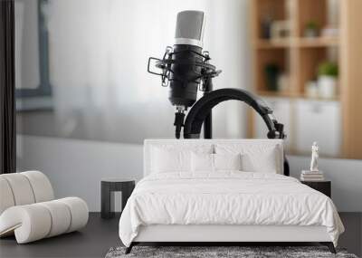 technology and audio equipment concept - headphones and microphone at home office or recording studio Wall mural