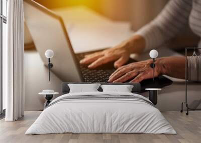 technology and people concept - close up of senior woman hands typing on laptop at home Wall mural