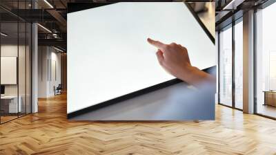 technology and people concept - hand on led light tablet or touch screen at night office Wall mural