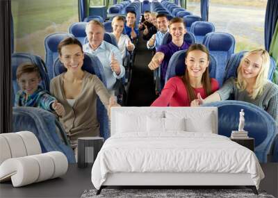 transport, tourism and travel concept - group of happy passengers travelling by bus and showing thumbs up Wall mural