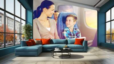 travel, tourism, family and technology concept - happy mother and son with tablet pc computer sitting in plane over porthole background Wall mural