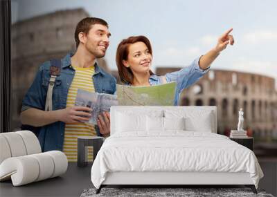 travel, tourism and vacation concept - happy couple of tourists with city guide, map and backpacks over coliseum background Wall mural