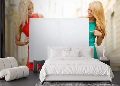 two happy blonde women with blank white board Wall mural