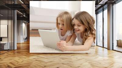 two little girls with tablet pc at home Wall mural