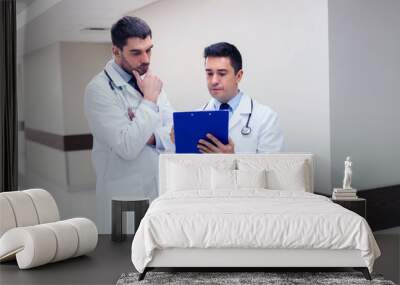 two male doctors with clipboard at hospital Wall mural