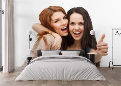 two smiling girls showing thumbs up Wall mural