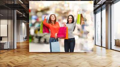 two smiling teenage girls with shopping bags Wall mural