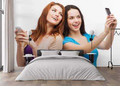 two smiling teenagers with smartphones Wall mural