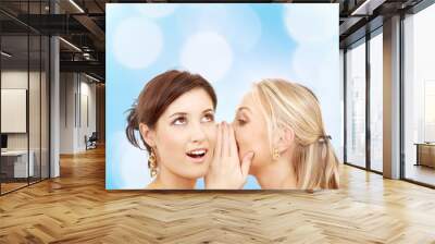 two smiling young women whispering gossip Wall mural