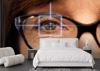 vision, eye surgery and ophthalmology concept - close up of face of senior woman in glasses with laser light Wall mural