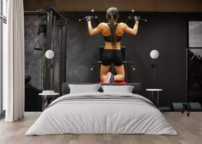 woman exercising and doing pull-ups in gym Wall mural