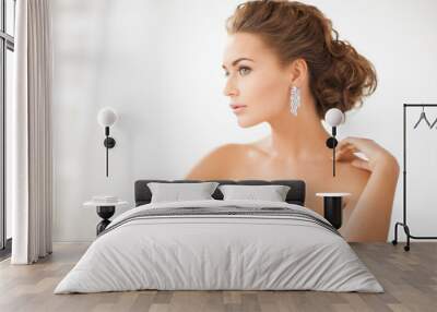 woman wearing shiny diamond earrings Wall mural