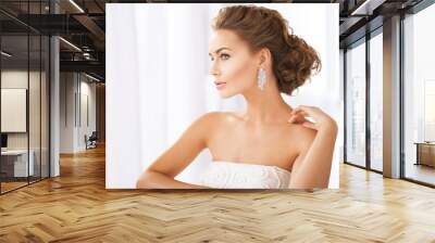 woman wearing shiny diamond earrings Wall mural