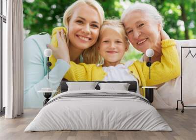 woman with daughter and senior mother at park Wall mural