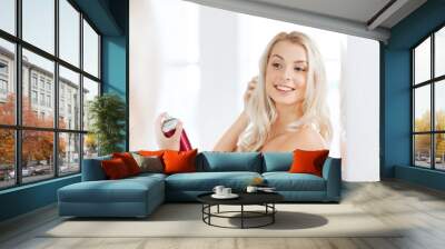 woman with hairspray styling her hair at bathroom Wall mural