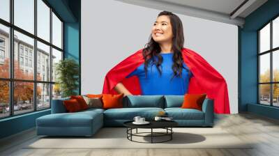 women's power and people concept - happy asian woman in red superhero cape over grey background Wall mural