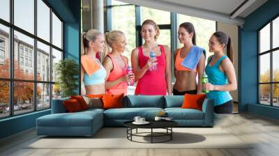 women with bottles of water in gym Wall mural