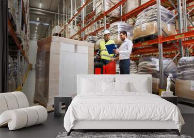 worker on forklift and businessman at warehouse Wall mural