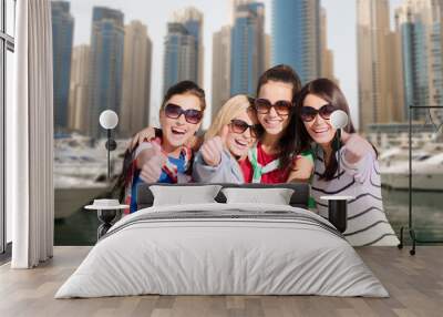 young women showing thumbs up over city harbour Wall mural