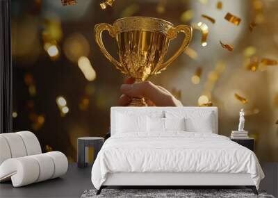 Hand holding gold trophy cup with confetti. celebrating with trophy award for success realistic image, ultra hd, high design very detailed Wall mural