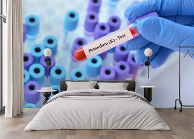 Doctor holding a test blood sample tube with potassium test on the background of medical test tubes with analyzes Wall mural