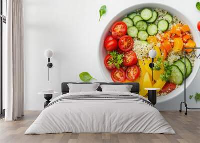 Quinoa salad with colorful cherry tomatoes and cucumbers is ready to be enjoyed as a healthy lunch. Fresh basil leaves are scattered around the white bowl Wall mural