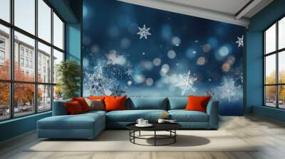 Snowflakes are falling on a snow covered surface with a dark blue background and bokeh. The image evokes a magical winter atmosphere Wall mural