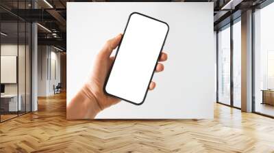 Woman hand holds smartphone with white screen. Female hand demonstrating new smartphone with blank screen Wall mural