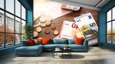 Euro banknotes and coins with bills to pay Wall mural