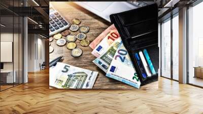 Euro banknotes and coins with wallet on work desk. Finances and budget Wall mural