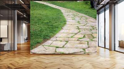 Stone paved ancient walkway on grass background. Wall mural