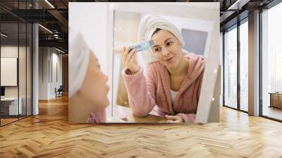 Girl doing deeply cleaning procedure with ultrasonic vibrations massager Wall mural