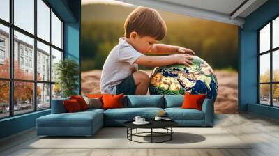 Child playing with Earth Planet ball toy on a hill, forest background, Earth Day concept Wall mural