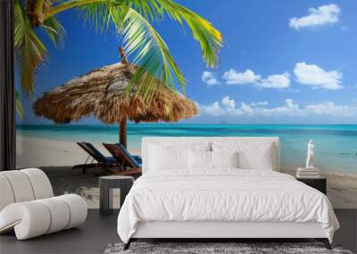 A beach scene with a large umbrella and two lounge chairs Wall mural