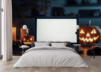 A laptop is on a table with three pumpkins and candles Wall mural