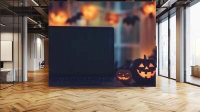 A laptop sits on a table with two pumpkins on it Wall mural