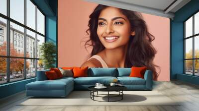 Beautiful smiling young indian woman, isolated on pink Wall mural