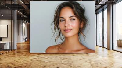 Beauty portrait of happy attractive young woman with glowing healthy radiant pure skin and beautiful hair. Pretty european girl model smiling on background advertising skin care cosmetic. Closeup face Wall mural