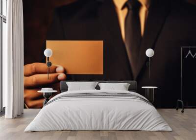 Businessman showing a blank business card. Closeup of a man in a suit holding a blank card. Wall mural