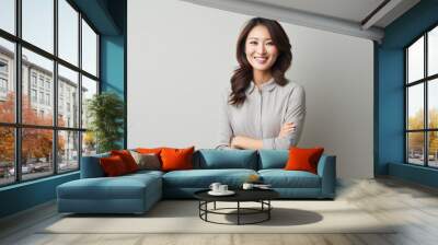 Confident asian business woman with arms crossed standing on grey background, asian. Wall mural